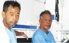  ??  ?? Tayudin Anjut (left) and Abd Rahim Summas sit inside an ambulance before being airlifted from a military hospital in Jolo town, Sulu province in southern island of Mindanao on March 23, to Zamboanga City after they were rescued in Sulu island. - AFP...
