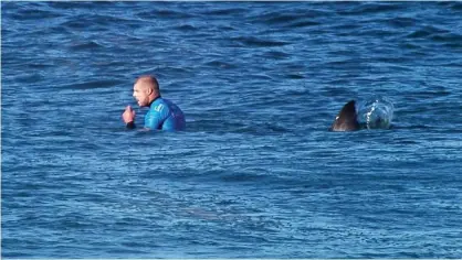 ??  ?? Surfer Mick Fanning fights off shark attack at J-Bay Open - video