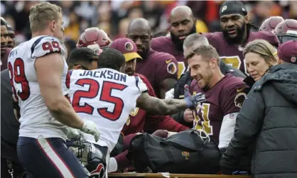  ??  ?? Alex Smith is comforted by teammates and opponents after his injury against the Houston Texans. Photograph: Mark Tenally/AP