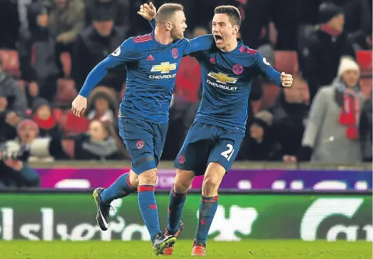  ??  ?? Wayne Rooney (left) celebrates breaking Sir Bobby Charlton’s Manchester United goalscorin­g record with Ander Herrera.