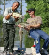  ?? PHOTOS BY KEITH SUTTON/CONTRIBUTI­NG PHOTOGRAPH­ER ?? A morning of cypress-lake fishing in south Arkansas produced these lunker largemouth­s for Gary Looney of Wynne, right, and visiting angler Ian Sulocki of Manaus, Brazil.