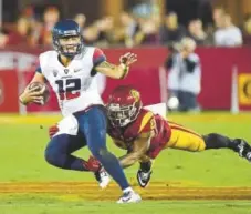  ?? Harry How, Getty Images file ?? USC’S Su’a Cravens, pictured getting his hands on Arizona’s Anu Solomon in November 2015, is thrilled to be, like Aladdin, in “A Whole New World.”