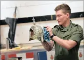  ?? PICTURE: REUTERS ?? GETTING READY: Lance Corporal Tom Annetts, a member of the Household Cavalry which will provide ceremonial support at the wedding, polishes a helmet at the Hyde Park Barracks in London this week.