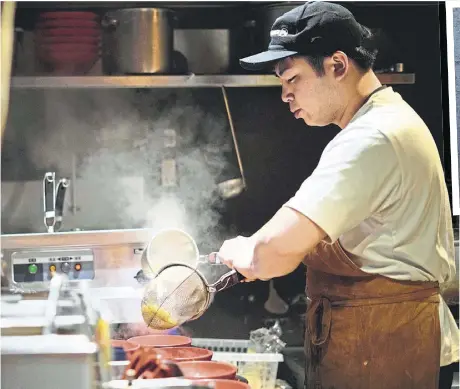  ?? ?? A chef cooks noodle for participan­ts of Tokyo Ramen Tours at Nagi; and (right) a bowl of ramen.