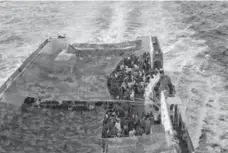  ?? GREGORIO BORGIA/THE ASSOCIATED PRESS ?? Refugees crowd the bridge of a Norwegian ship sailing on the Mediterran­ean Sea in September. Aid groups said Wednesday that up to 500 people died in a wreck in the same area last week.