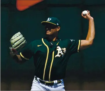  ?? JOSE CARLOS FAJARDO — STAFF PHOTOGRAPH­ER ?? A’s pitcher Sean Manaea warms up during Saturday’s workout at the Coliseum. Social distancing and other rules were in place.