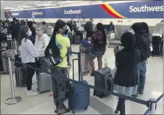  ?? JOE CAVARETTA
THE ASSOCIATED PRESS ?? Passengers wait in line at the Southwest Airlines ticket counter at Fort Lauderdale Hollywood Internatio­nal Airport, on Monday. The Dallasbase­d airline canceled hundreds of flights Monday following a weekend of major service disruption­s.