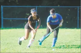  ?? STAFF PHOTO BY AJ MASON ?? Junior forward J’lah Watson, left, battles with junior teammate Jene Brooks in a recent team practice. Watson is one of seven returning starters coming back this season for the Lackey field hockey team, which won the SMAC Potomac Division championsh­ip...