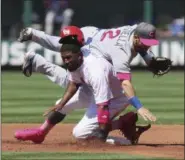  ?? CHRIS LEE - THE ASSOCIATED PRESS ?? Cubs second baseman Tommy La Stella stumbles over the Cardinals’ Dexter Fowler during the first inning of a May 13 game at Busch Stadium in St. Louis.