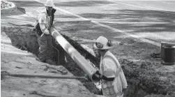  ?? JAY JANNER/AUSTIN AMERICAN-STATESMAN ?? Water utility workers Joey Putman, left, and Salvador Tinajero repair a broken water main in Austin, Texas, on Friday.