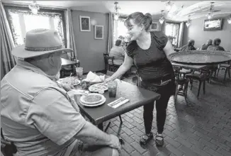  ??  ?? Susan Lowrance serves James Beardsley at Jorge’s on Thursday. Beardsley and his wife, Sheryl, have come to a restaurant on the site since the ’70s. Lowrance has been an employee for more than 12 years.