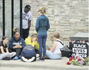  ??  ?? Mourners gather around a makeshift memorial near where a black man was arrested by police and later died, Minneapoli­s, Minnesota, May 26, 2020.