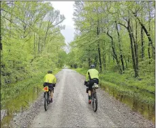  ?? Courtesy photo ?? Allie Corlett (left) and Chris Brosh pedal across the Delta region where the Ozark mountains gave way to the flatlands.