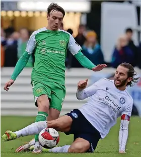  ?? Pictures: Phil Mingo/Pinnacle ?? Yate Town’s Dave Sims-Burgess slides in to tackle Yeovil’s Dan Moss during Saturday’s FA Cup tie at Lodge Road