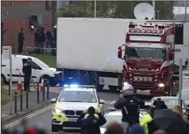  ?? ALASTAIR GRANT — THE ASSOCIATED PRESS ?? Police escort a truck that was found to contain 39bodies, as they move it from an industrial estate in Thurrock, south England, on Wednesday.