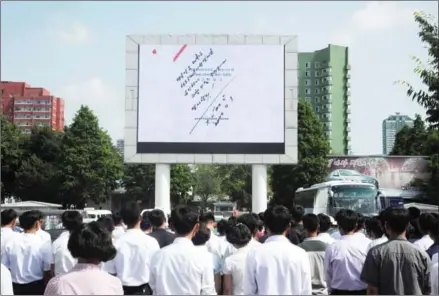 ?? KIM WON-JIN/AFP ?? The order to carry out the test-fire of the interconti­nental ballistic missile Hwasong-14 as signed by North Korean leader Kim Jongun is seen on a big screen near the Pyongyang Railway Station in Pyongyang yesterday.