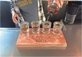  ?? PHOTOS BY ASHLEY DAY, USA TODAY ?? At Traverse City Whiskey Co., you can try a flight of four varieties, including bourbon whiskey infused with cherries.