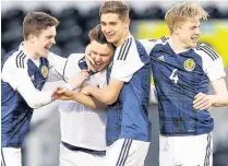  ??  ?? HERE WE CRO Glenn Middleton rifles home Scotland’s winner before being mobbed by team-mates