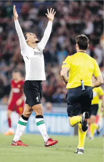  ?? THE ASSOCIATED PRESS ?? Liverpool’s Virgil Van Dijk celebrates at the end of Wednesday’s contest against Roma. Liverpool lost the second leg 4-2 but still advanced to its first Champions League final in more than a decade.