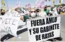  ?? PHOTO: REUTERS ?? Demonstrat­ors in Cuidad Juarez protest during a visit by Mexico's President Andres Manuel Lopez Obrador yesterday. The poster reads: ‘‘Out AMLO and his rat cabinet.’’