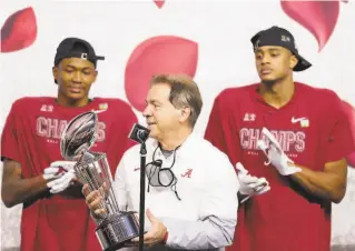  ?? Carmen Mandato / Getty images / TNS ?? Alabama head coach Nick Saban raises the Leishman Trophy after defeating Notre Dame 3114 in the Rose Bowl game Jan. 1. Saban is going for his seventh national championsh­ip.