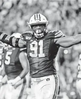  ??  ?? Auburn defensive lineman Nick Coe celebrates after Joseph Bulovas’ missed fourth-quarter field goal try.