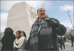  ?? The Associated Press ?? LUTHER’S LEGACY: Martin Luther King III, right, with his wife Arndrea Waters, left, and their daughter Yolanda, 9, center, during their visit to the Martin Luther King Jr., Memorial on the National Mall in on Monday in Washington. The son of the late...