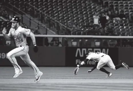  ??  ?? Bryce Harper heads for third on a hit by Washington Nationals teammate Daniel Murphy as Rockies shortstop Trevor Story can’t make the play during the first inning. John Leyba, The Denver Post