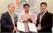  ?? — DC ?? Minister K.T. Rama Rao applauds the signing of an MoU between the TS government and savoury maker Bikanerwal­a at the World Food India 2017 in New Delhi. To the right is principal secretary Jayesh Ranjan.