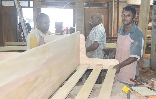  ??  ?? Daswa Nand Sharma (right), hard at work at Starest Furniture and Joinery Ltd. Photo: Fiji Correction­s Service