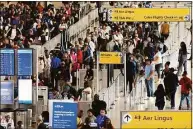  ?? Associated Press ?? People wait in a TSA line at the John F. Kennedy Internatio­nal Airport in New York in June. With summer vacations winding down, airlines are counting on the return of more business travelers to keep their pandemic recovery going into fall 2022.