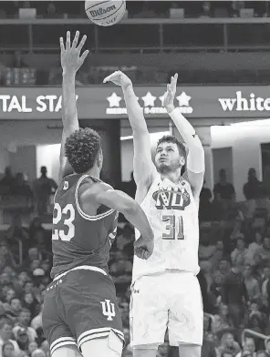  ?? NAM Y. HUH/ AP ?? Northweste­rn forward Robbie Beran shoots over Indiana forward Trayce Jackson- Davis on Wednesday in Evanston, Illinois.