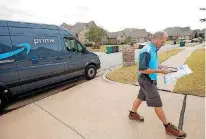  ??  ?? Anthony Miller, with Crimson Transport, makes a delivery Tuesday for Amazon in Oklahoma City.