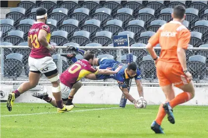  ?? PHOTO: GREGOR RICHARDSON ?? Touchdown . . . Otago winger Jona Nareki scores in the corner despite the efforts of Southland first fiveeighth Scott Eade during a Mitre 10 Cup match against Southland at Forsyth Barr Stadium on Saturday. The Southland centre is Neria Fomai, while...