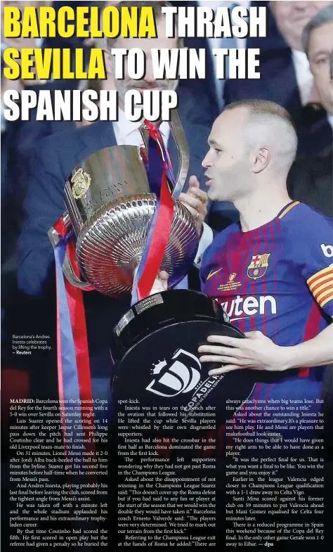  ?? — Reuters ?? Barcelona’s Andres Iniesta celebrates by lifting the trophy.