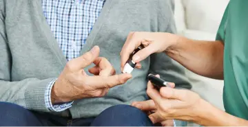  ??  ?? CHECKING: Blood glucose is monitored on the finger of a man with diabetes.
