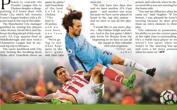  ?? REUTERS PIC ?? Manchester City’s David Silva (right) is tackled by Stoke’s Geoff Cameron in their Premier League match on Wednesday.