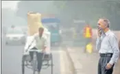  ?? BIPLOV BHUYAN/HT PHOTO ?? ■
A man covers his face near ISBT on Sunday.