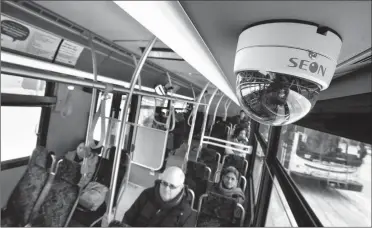  ?? Herald photo by Ian Martens ?? A video surveillan­ce camera hangs above transit riders in a city bus waiting to leave Monday from the 4th Avenue downtown bus stop. @IMartensHe­rald