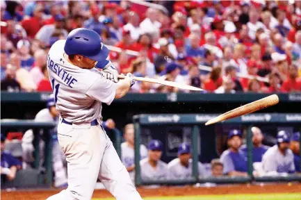  ??  ?? Los Angeles Dodgers third baseman Logan Forsythe breaks his bat as he hits a force out during the fifth inning against the St. Louis Cardinals at Busch Stadium on Tuesday. (USA TODAY Sports)