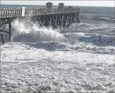  ?? Donna merchant / Special to the times union ?? donna merchant, a native of Schenectad­y who now lives year-round in Palm Coast, florida, took this photo of waves crashing into the pier at flagler Beach. merchant and her husband, Ken, intend to ride out the hurricane, their first, in their new home.