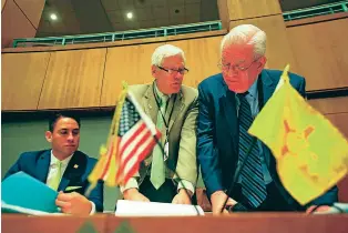  ?? GABRIELA CAMPOS/NEW MEXICAN FILE PHOTO ?? David Abbey, center, director of the Legislativ­e Finance Committee, flanked by then-state Sens. Howie Morales and John Arthur Smith, review a budget plan in 2018 on the Senate floor. Abbey announced his retirement last week.