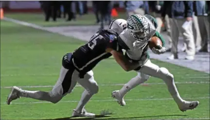  ?? PETE BANNAN — DIGITAL FIRST MEDIA ?? Pennridge reciever Joe Devine (6) is tackled by Garnet Valley’s Brandon DiCamillo after catching a pass in the first quarter of the PIAA Class 6A District semifinals against Garnet Valley Friday evening.