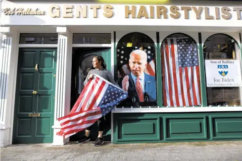  ?? PETER MORRISON/AP ?? Catherine Hallahan waits for the celebratio­ns to start in Ballina, Ireland, on Nov. 7. Ballina is the ancestral home of now-President Joe Biden.