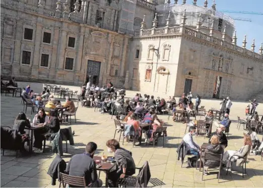  ??  ?? Clientes en una terraza en el corazón de la zona vieja compostela­na, tras la relajación de las medidas