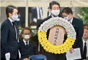  ?? — AFP ?? Japanese PM Shinzo Abe lays a wreath to mark the 75th anniversar­y of the atomic bombing of Nagasaki, at the Nagasaki Peace Park on Sunday.