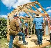  ?? LISA KOGAN/AMIKAS ?? Community members come together to help build cabins for mothers with children on property owned by Meridian Baptist Church in El Cajon, California.