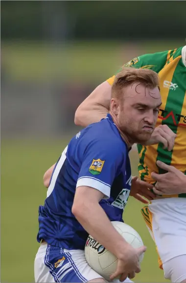  ??  ?? Conor Noonan, Clan na Gael, keeps the pressure up on Paudy Clarke, Ardee St. Mary’s. Pictures: Ken Finegan