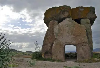  ??  ?? The Dolmen di Sa Coveccada, an ancient megalithic grave, in Sardinia, Italy.