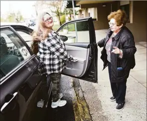  ?? Tyler Sizemore / Hearst Connecticu­t Media ?? FISH of Stamford volunteer driver Cheryl Kendall, right, opens the door for FISH client Mary Ann Novak outside her apartment in Stamford on April 26. FISH is a local organizati­on that provides free rides to Stamford residents for medical appointmen­ts. The organizati­on is celebratin­g 50 years in operation this year.